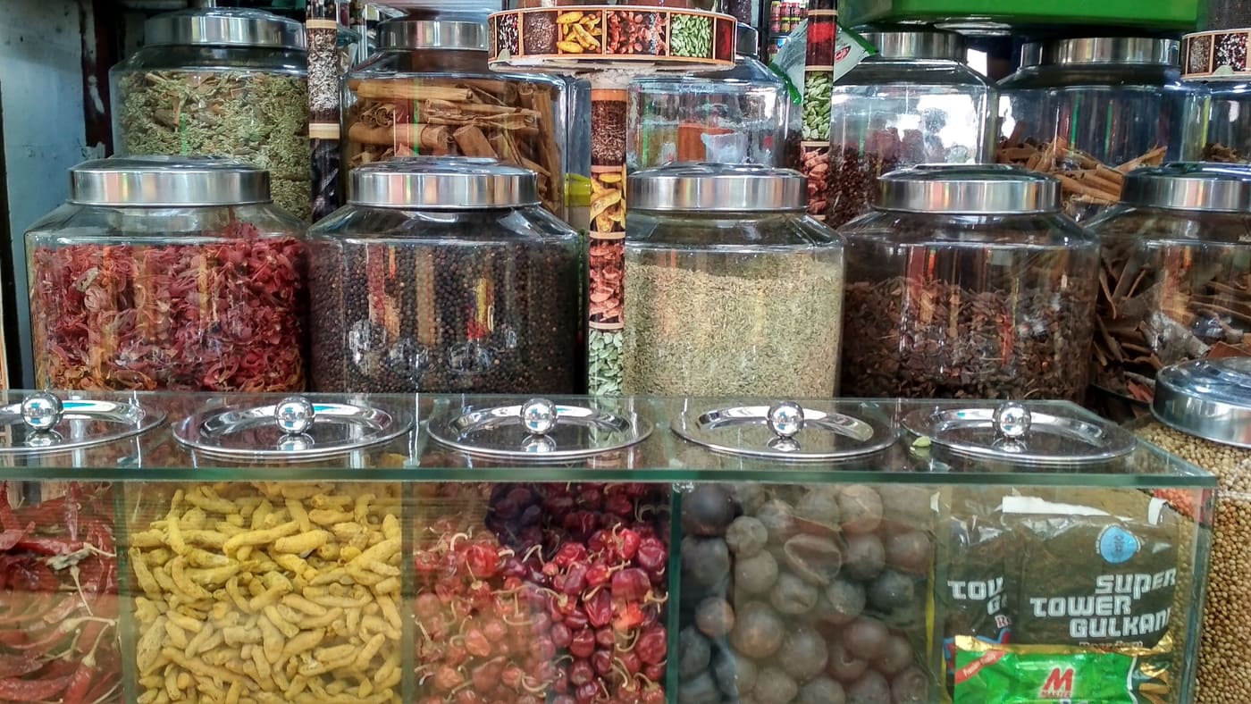 Jars of spices and dried goods in a Palayam market shop, Thiruvananthapuram