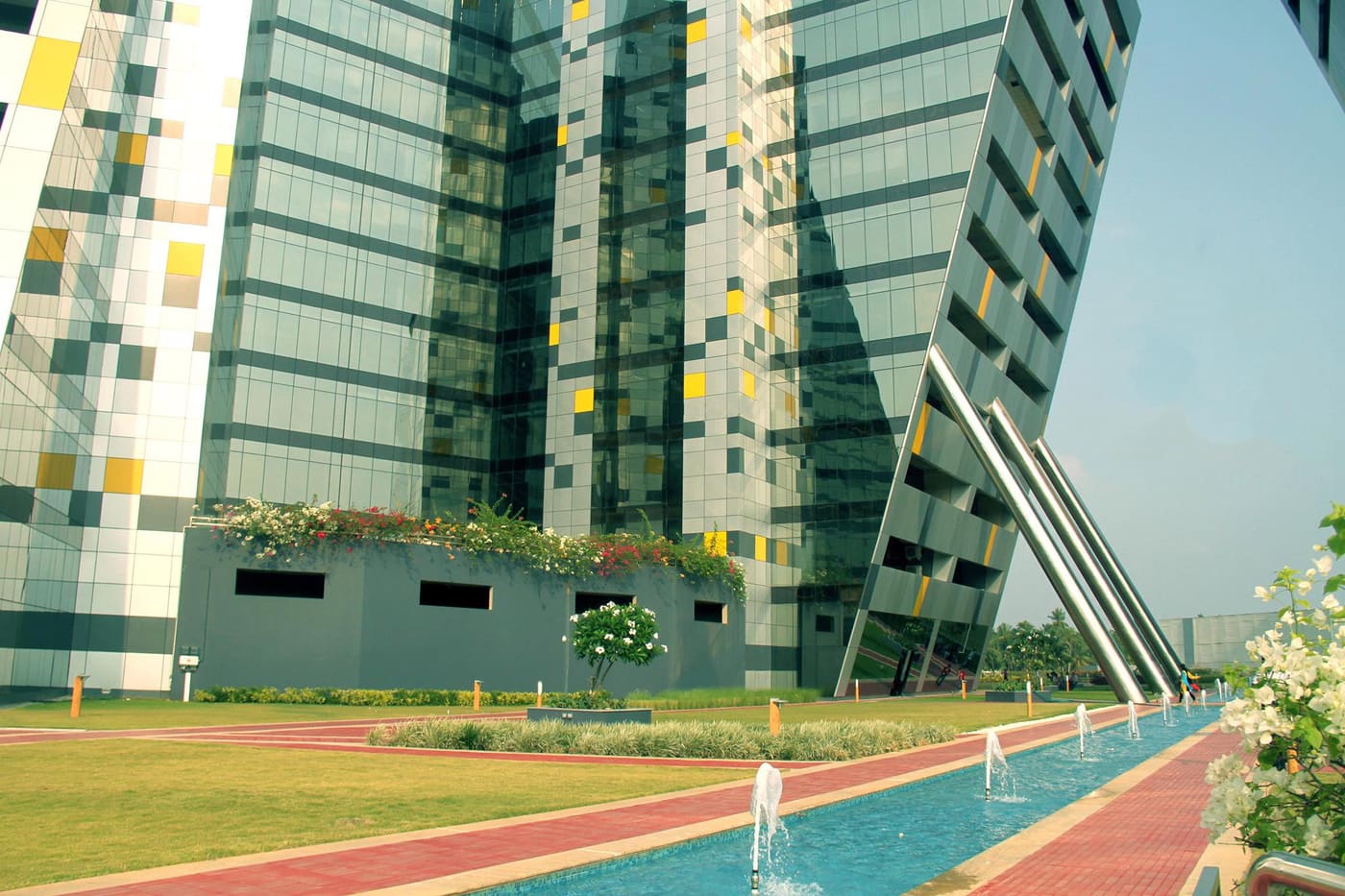 Glass office towers and a landscaped water feature at Technopark